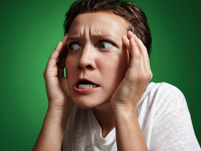 woman with crazy surprised face touching head